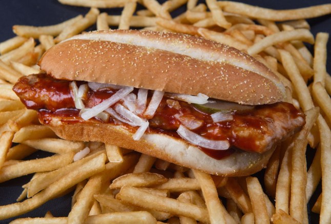 The McRib from McDonald's on top of french fries