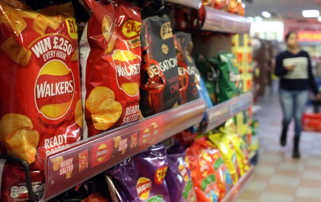 Packets of Walkers crisps are display for sale inside a store in the UK