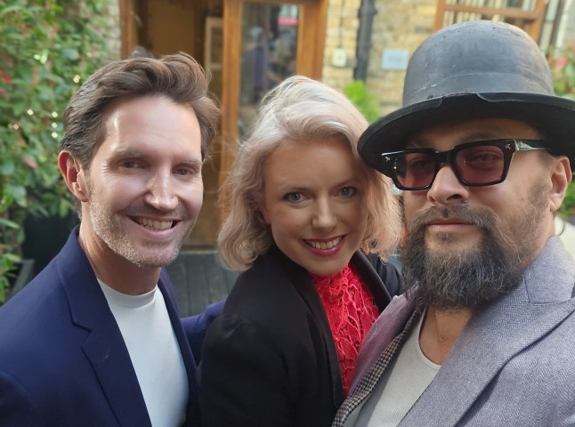 Rob Buckhaven and his friend Clara Batten posing with Jason Momoa.