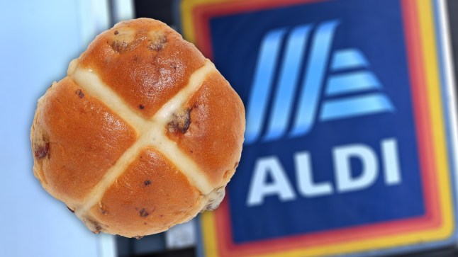 A hot cross bun in front of an Aldi supermarket sign.