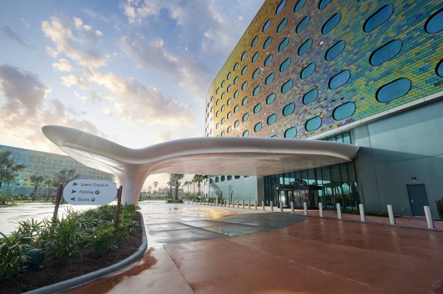 Exterior of Universal Studios' Terra Luna resort in Orlando, Florida, with colourful walls, curved windows and an unusual canopy.