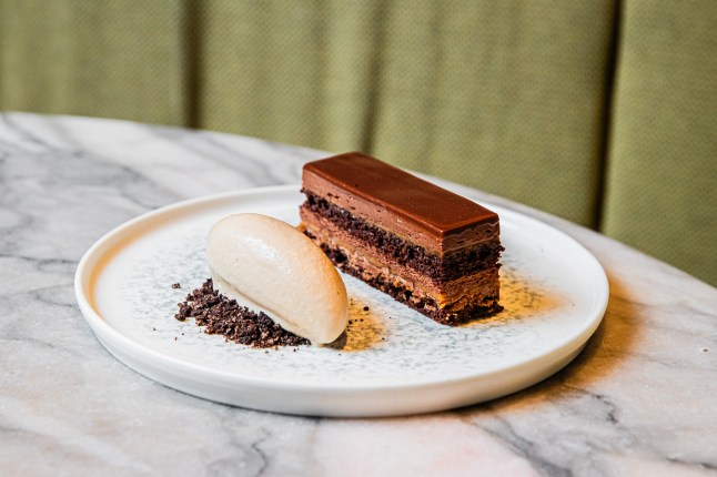 A chocolate dessert on a white plate with sorbet at Kiln restaurant, in Sydney