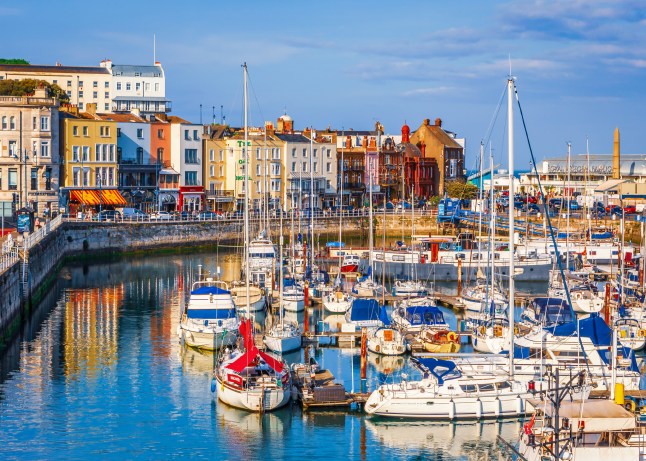 The bright colourful buildings, cafes and restaurants along the quayside of the impressive historic Royal Harbour in Ramsgate, Kent.