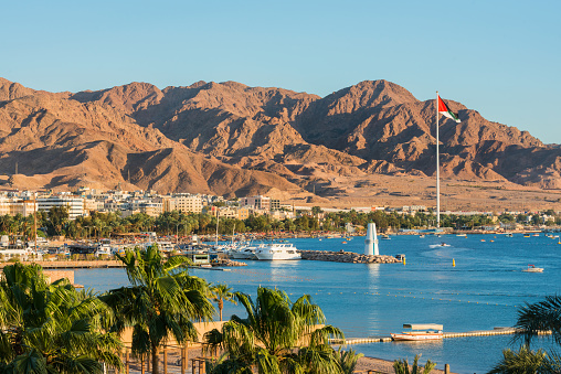 Scenic view of sea and mountains against blue sky in Aqaba, Jordan