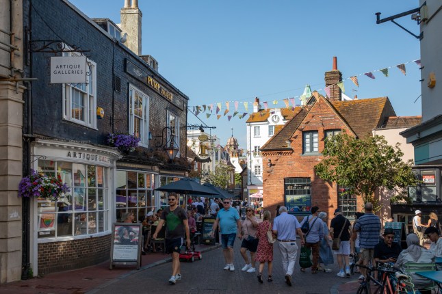 People walking in a popular shopping area with beautiful architectures of Brighton city in UK