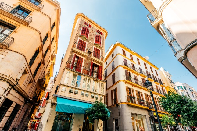 A view of a traditional Spanish building on a street in Palma, Majorca, on a sunny day