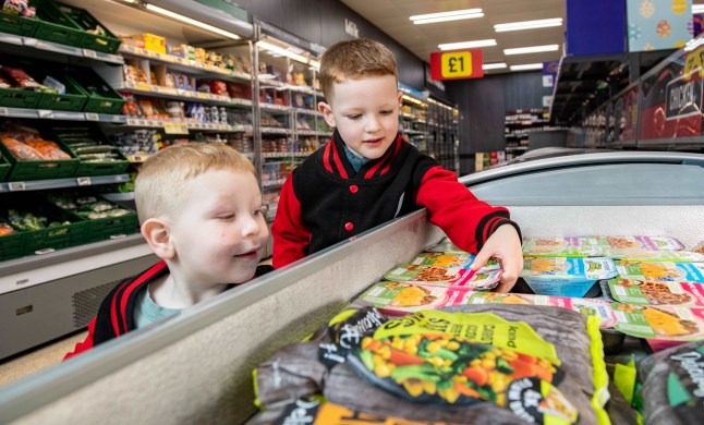 Children looking at the Mumsnet ready meals in Iceland store