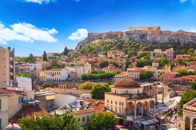 The skyline of Athens, Greece during sunset, showing Monastiraki square and the Acropolis hill.