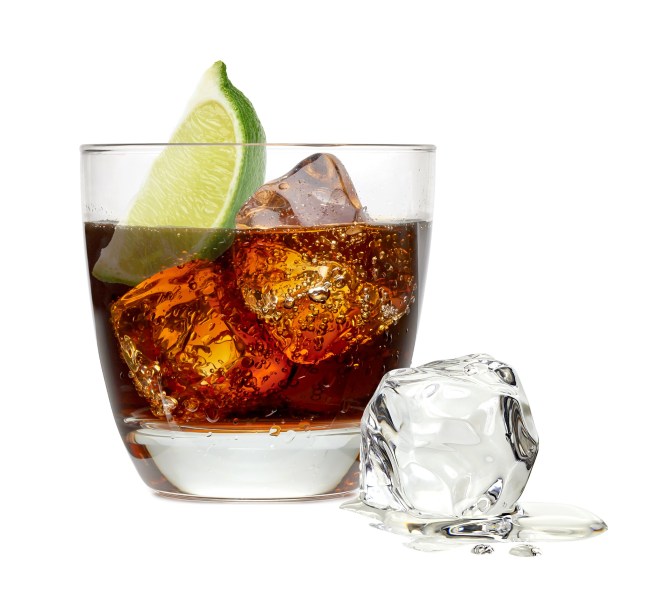 Cuba libre drink or tequila cocktail with ice cubes and lime wedge in collins or rocks glass isolated on white background; Shutterstock ID 322743221; purchase_order: -; job: -; client: -; other: -