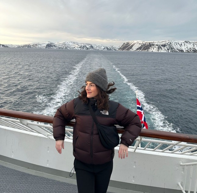 Alice on the bow of the Nordkapp sailing through the Barents Sea