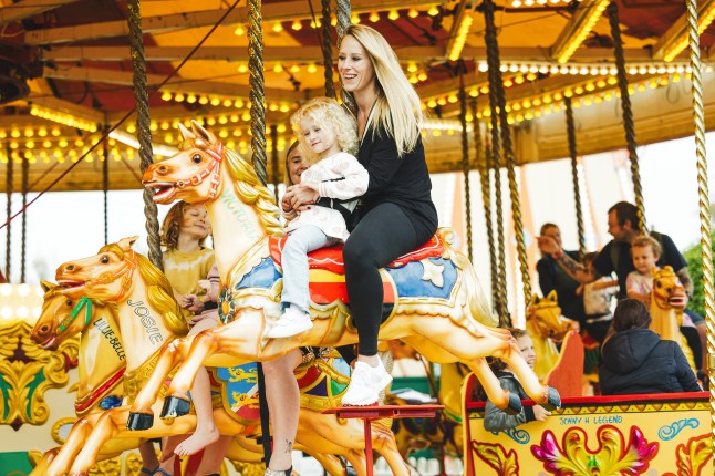 A mother and child riding the carousel at Butlin's holiday park.