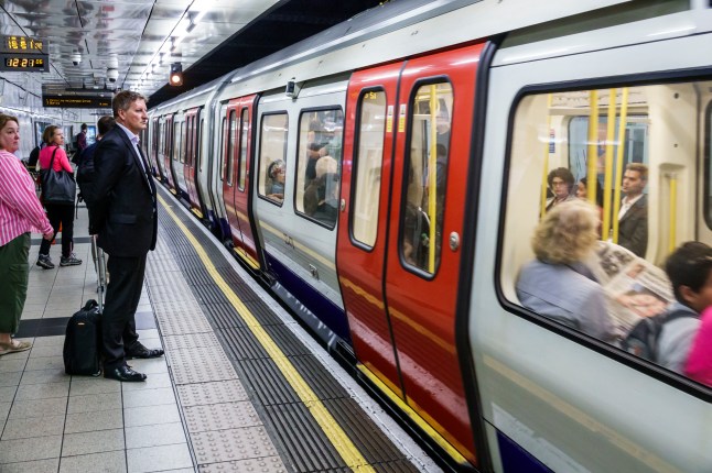 Passengers waiting at a London Underground station to board the Tube.
