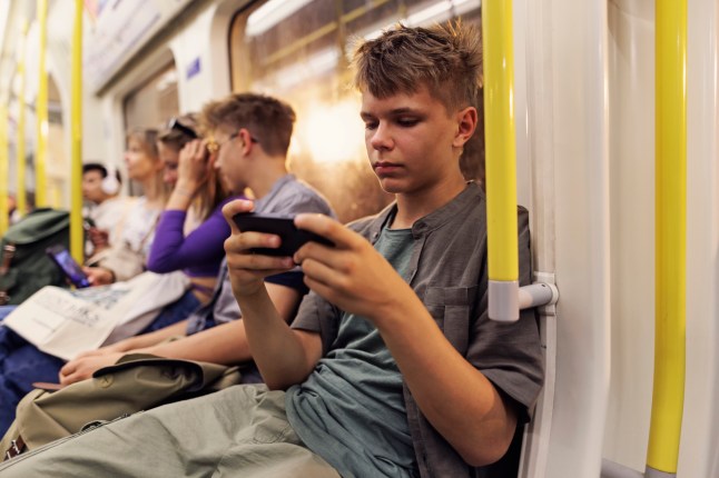 Teenagers travelling in London train