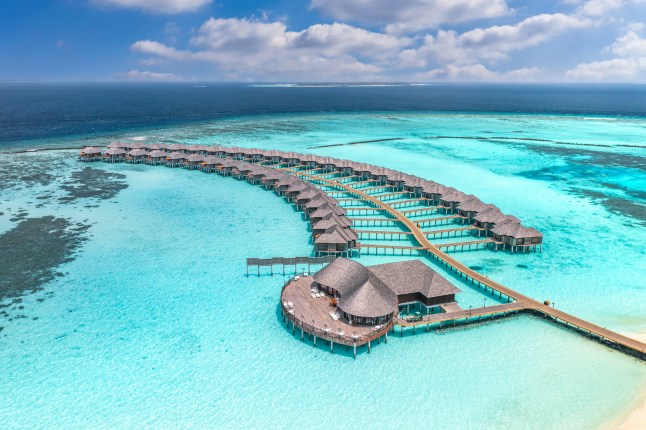 An aerial view of over water villas in the Maldives