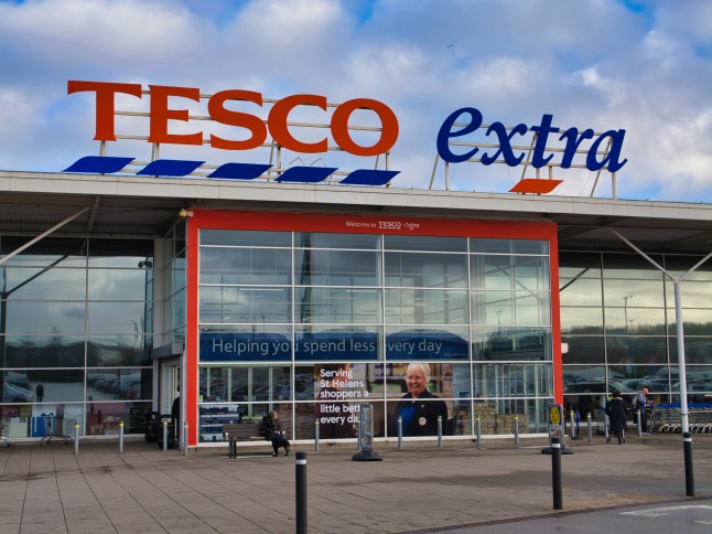 Corporate signage and the customer entrance at a Tesco Extra superstore.
