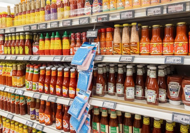 Sauces, condiments, bottles on shelves in FairPrice supermarket Singapore