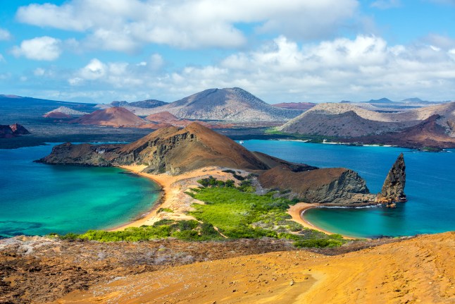View from Bartolome Island on the Galapagos Islands. The ocean is blue on either side of a narrow archipelago