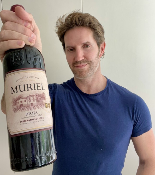 Rob Buckhaven holding a bottle of Muriel Tempranillo Vendimia Seleccionada Rioja from Co-op