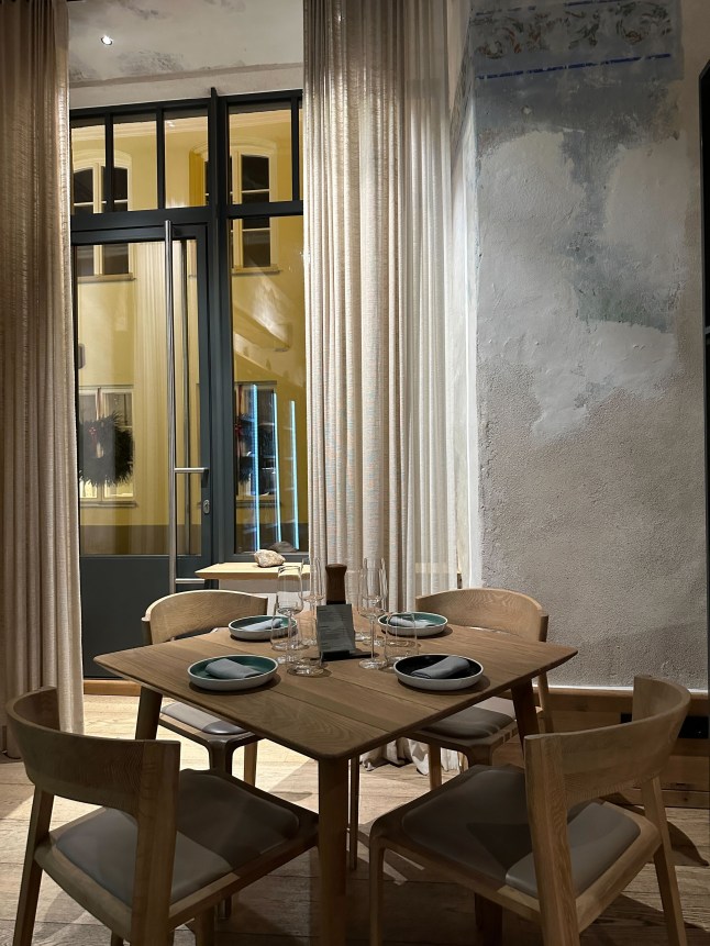 A table set for four with a window in the background