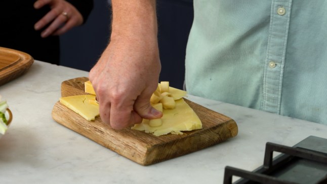 Jamie Oliver uses a Salt & Vinegar Hula Hoop to cut some cheese