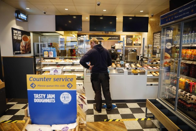A customer shops inside a reopned Greggs bakery in London on June 18, 2020 after the chain reopened hundreds of stores around the UK following their coronavirus shutdown. - Greggs reopened 800 of its stores throughout the UK for takeaway with new safety measures in place following its shutdown in because of the novel coronavirus pandemic. (Photo by Tolga Akmen / AFP) (Photo by TOLGA AKMEN/AFP via Getty Images)