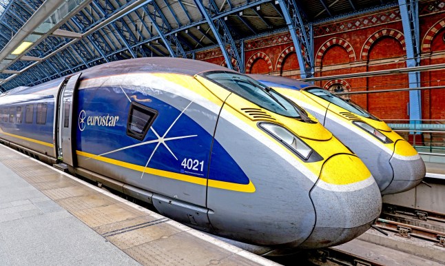 Two Eurostar trains sitting at London St. Pancras International railway station.
