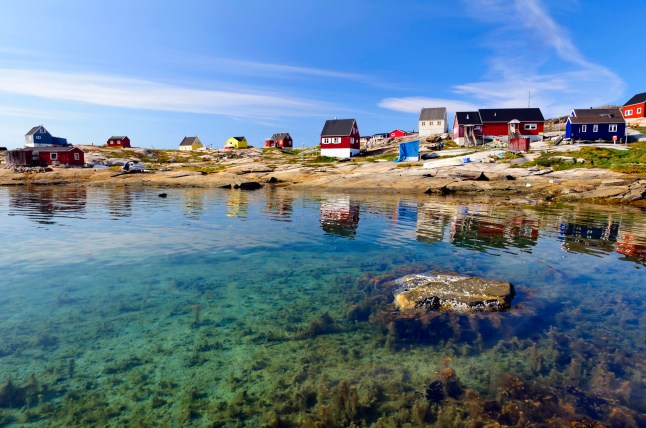 A sunny view over a body of water in Oqaatsut, formerly Rodebay, in western Greenland.