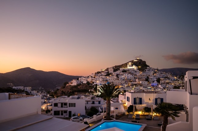 kastos, Greece - September 2023 : View of a picturesque hotel with swimming pool and the whitewashed village of in Greece