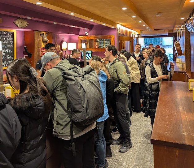 Crowds of people inside a tiny pintxos bar in San Sebastian, Spain