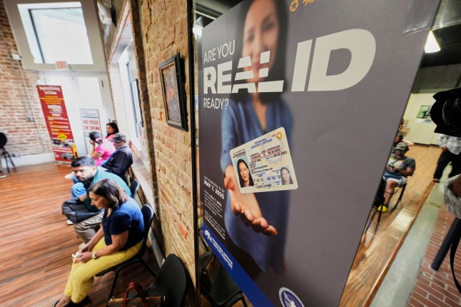 People wait inside a branch of the Louisiana Office of Motor Vehicles in Kenner, La., Tuesday, May 6, 2025. (AP Photo/Gerald Herbert)