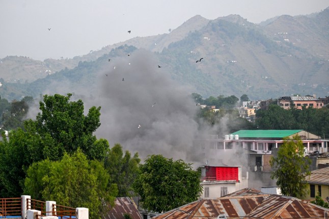 Smoke billows after an artillery shell landed in the main town of Poonch district in India's Jammu region on May 7, 2025. At least eight Indians were killed and 29 others wounded Wednesday in the town of Poonch in Kashmir, close to the de facto border with Pakistan, a local Indian government official said.