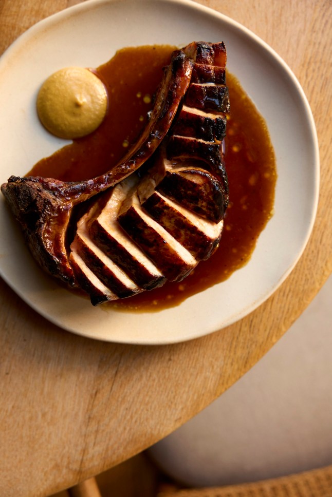 The pork chops from Dove on a plate on a table