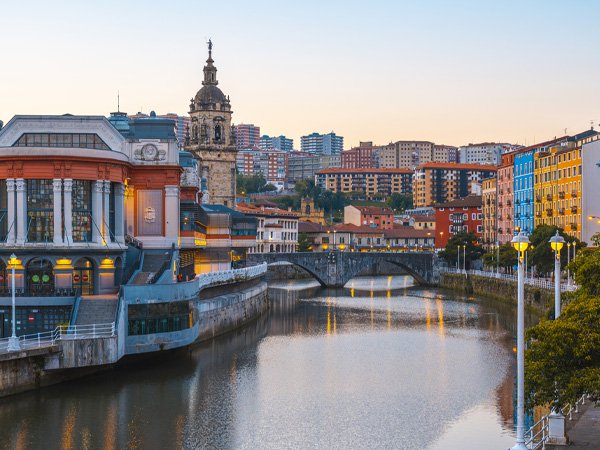 Old town and river in Bilbao, Spain at sunset