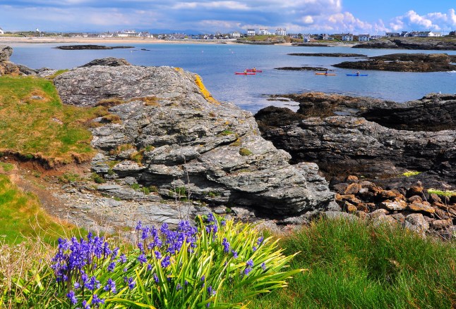 Rocks overlook Trearddur Bay Beach in Wales.