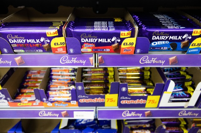 Bars of Cadbury Dairy Milk chocolate in a shop.