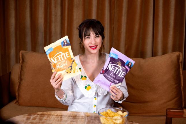 Rachel Khoo holding up the packets of new French-inspired Kettle Chips